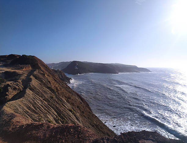 istock Dramatic coastal scene featuring a rugged cliffside overlooking a vast ocean under a clear, sunny sky. Perfect for travel, adventure, or environmental themes. 2212475098