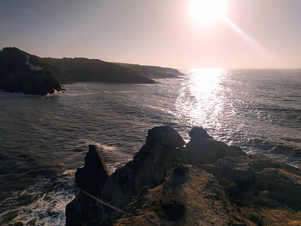 istock Dramatic coastline view featuring a rugged cliffside overlooking the sparkling ocean at sunset. Evokes serenity, adventure, and the power of nature. Ideal for travel and landscape projects. 2212475133