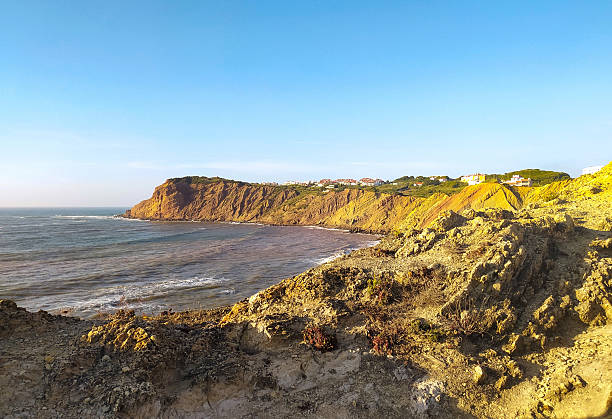 istock Serene coastal landscape featuring dramatic cliffs meeting the ocean under a clear blue sky. Perfect for travel, nature, or inspirational themes. 2212475148