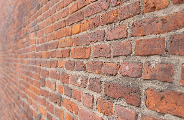 istock texture dark brick wall of old castle, ancient red stone background. 2212475336