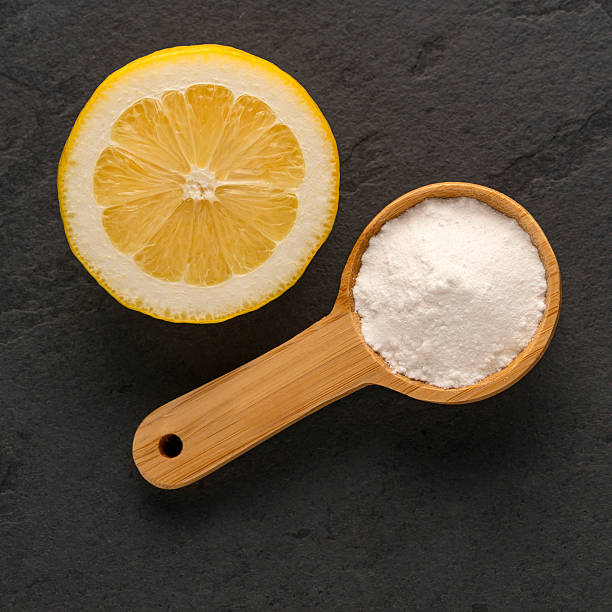 istock Baking soda on a spoon with lemon - Citrus Limon 2212487254
