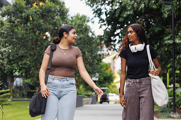 istock Two Aboriginal Australian friends walking through university campus together 2212488915