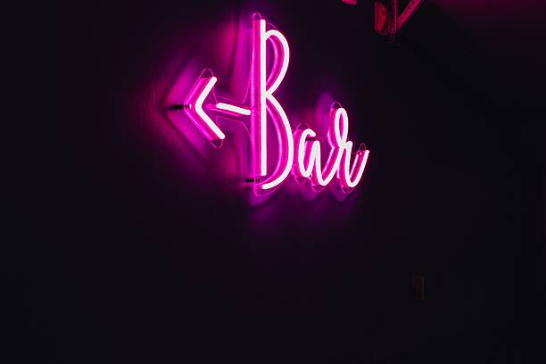 istock Pink neon Bar sign with arrow at night 2212489995