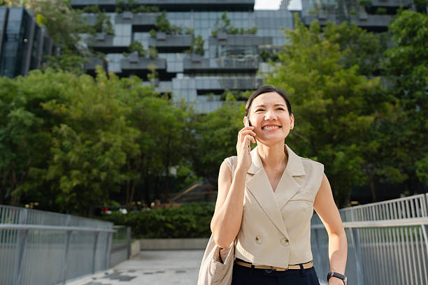 istock Businesswoman talking on the phone while walking to work 2212496044