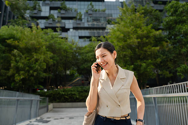 istock Businesswoman talking on the phone while walking to work 2212496064