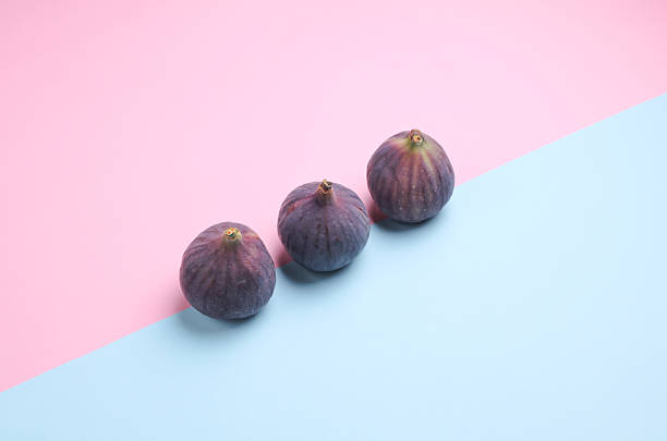 Ripe fig fruits on blue pink background. Top view