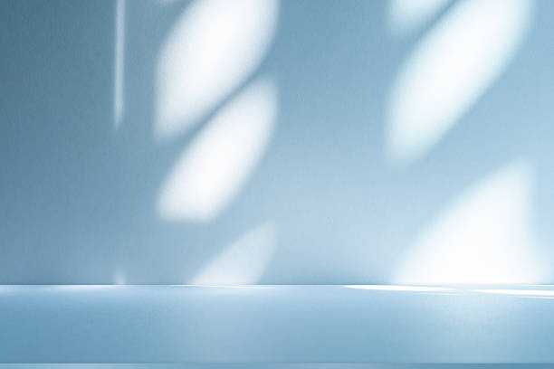 istock Studio style background wall decoration presentation uses white and blue tones. with shadows cast from a nearby window, concept creating a decorative 2212499469