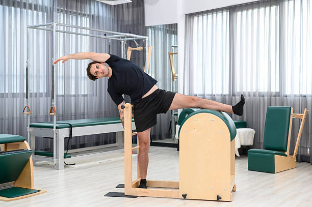 istock A young Sportsman training pilates using reformers machine for body stretching during class in modern fitness studio 2212500793