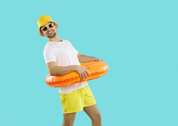istock Smiling man in lifebuoy excited about summer time 2212501656