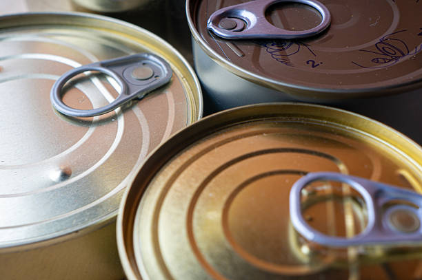 Round tin cans with food on the surface