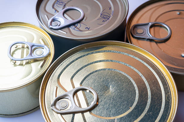 Round tin cans with food on the surface