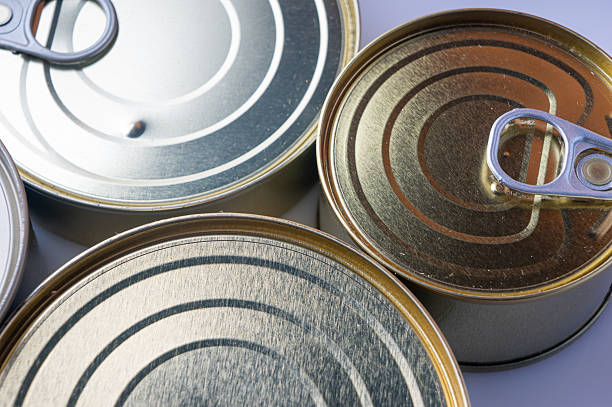 Round tin cans with food on the surface