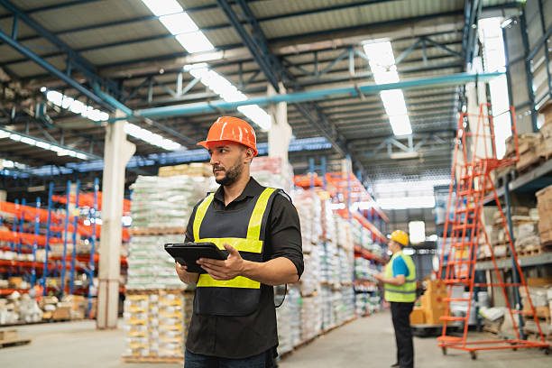 istock Professional Warehouse Worker Using Tablet for Inventory Management in Modern Distribution Center 2212505053