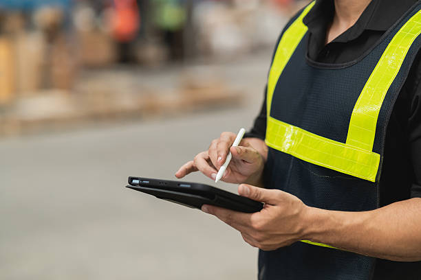 istock Worker Using Digital Tablet with Stylus in Warehouse Setting for Inventory Management and Logistic Operations 2212505056