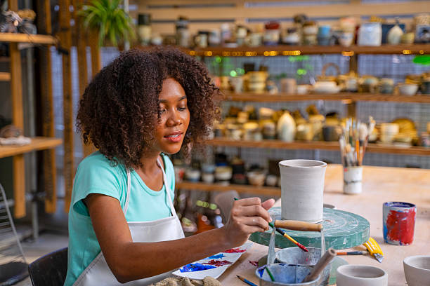 istock African woman make earth ware at workshop. 2212506979