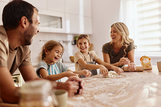 istock Happy family enjoying while making a cake at home. 2212510067