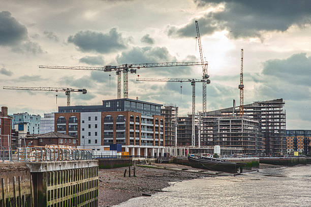Construction site with tower cranes and unfinished buildings stock photo