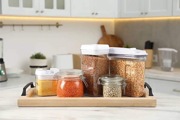 istock Different types of cereals and legumes in containers on white marble table in kitchen 2212513621