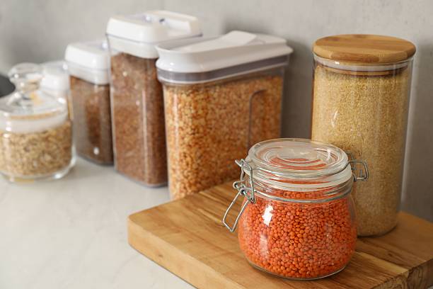 istock Different types of cereals and legumes in containers on light table 2212513625