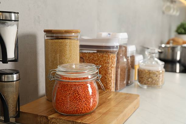 istock Different types of cereals and legumes in containers on light table 2212513769