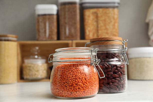 istock Different legumes in containers on light table, closeup 2212513773