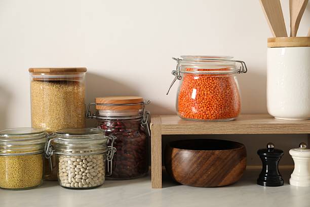 istock Different types of cereals and legumes in containers on light marble table in kitchen 2212513774