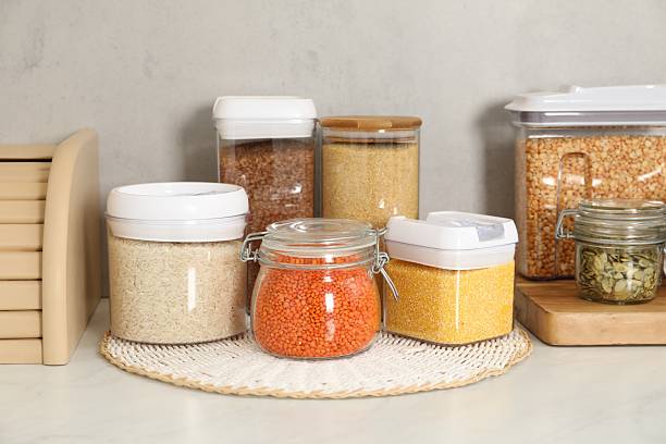 istock Different types of cereals, seeds and legumes in containers on light marble table 2212513789
