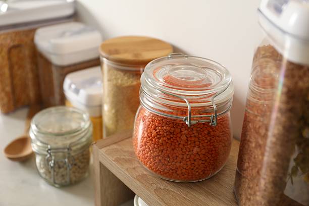 istock Different types of cereals and legumes in containers on light table, closeup 2212513796