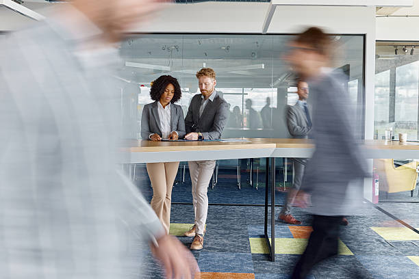 istock Young business people working on reports among colleagues in blurred motion. 2212513822