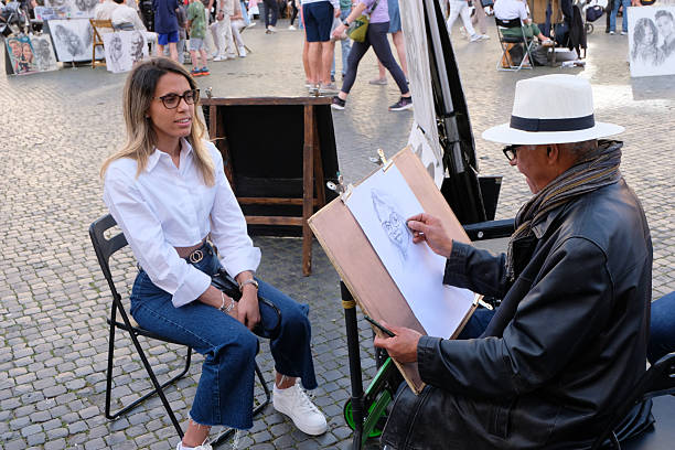 Rome, Italy, april 21, 2025 : Cartoonist at work in Piazza Navona in Rome