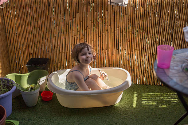 istock A child happily playing in a mini bathtub on a bright sunny terrace 2212515249