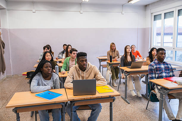 istock High school students listening attentively in class 2212519308