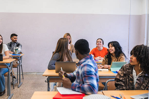 istock High school students listening to teacher in classroom 2212519664