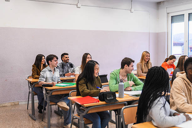 istock High school students listening attentively in class 2212520109
