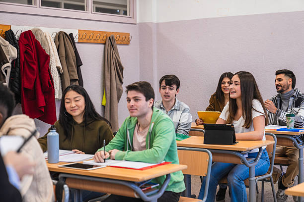 istock High school students listening to teacher in classroom 2212520394