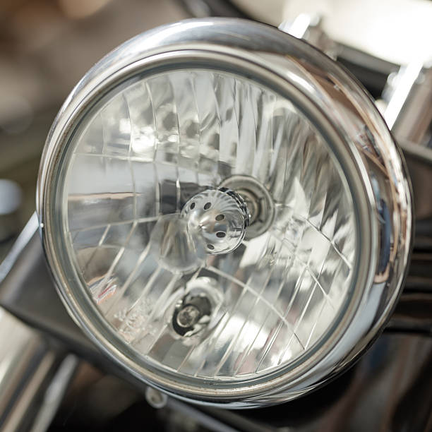 istock Close-up View of a Shiny Motorcycle Headlight Reflecting Light 2212520896