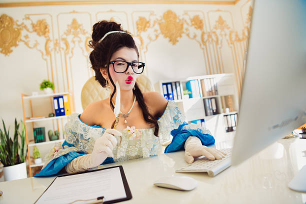 istock Young woman dressed in historical aristocratic attire multitasking at a modern office workspace 2212520899
