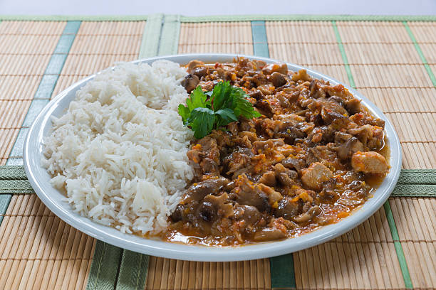 Dish with meat stew homemade, rice basmati, honey mushrooms and some  parsley leaves in the center