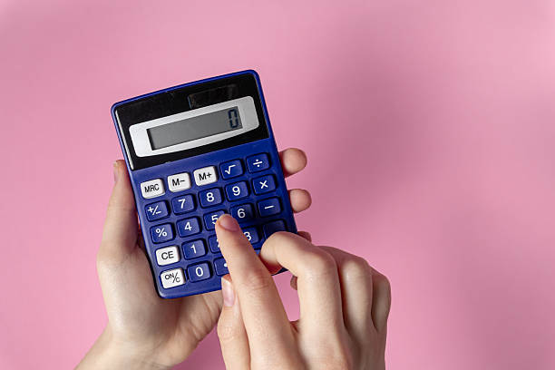 istock Hands using blue calculator against pink background express budgeting, control, and calculation 2212521365