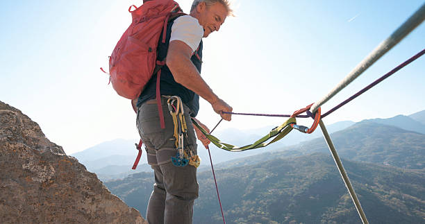 istock View down safety rope to climber on mountain top 2212523242