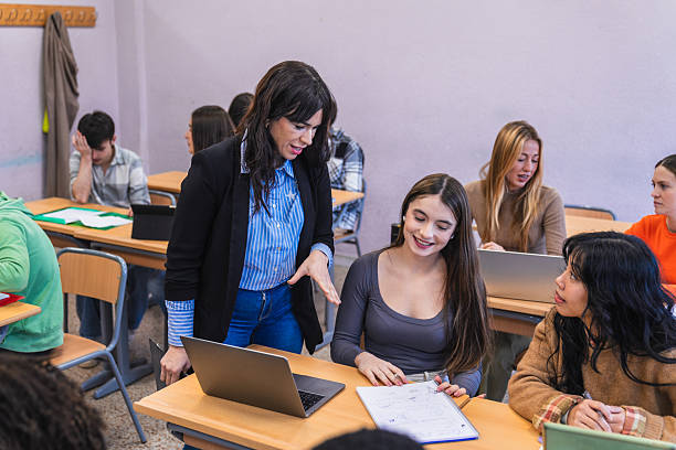 istock High school teacher helping students with their project 2212523244