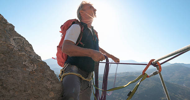 istock View down safety rope to climber on mountain top 2212523253