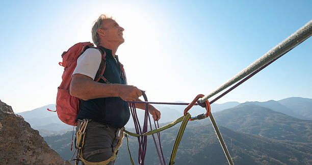 istock View down safety rope to climber on mountain top 2212523259