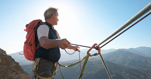 istock View down safety rope to climber on mountain top 2212523390