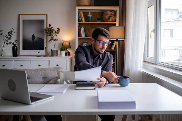 istock Focused man working on laptop in modern office environment. 2212523499