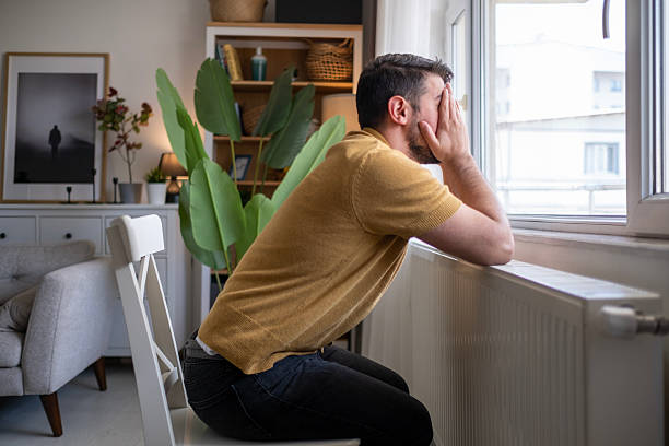 istock Exhausted man sitting at the office desk and touching her head, she has a headache 2212523793