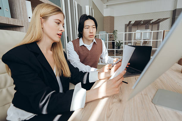 istock Business partners reviewing documents at office desk 2212526233
