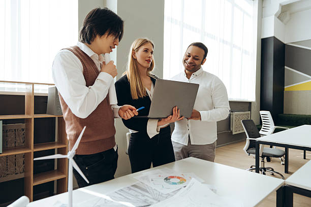 istock Engineers discussing project on laptop in modern office 2212526309