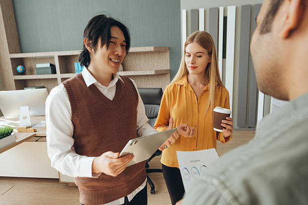 istock Business team discussing marketing strategy using tablet and documents during a meeting in the office 2212526371