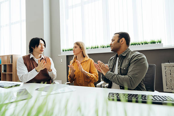 istock Business team clapping hands during a meeting in the office 2212526442